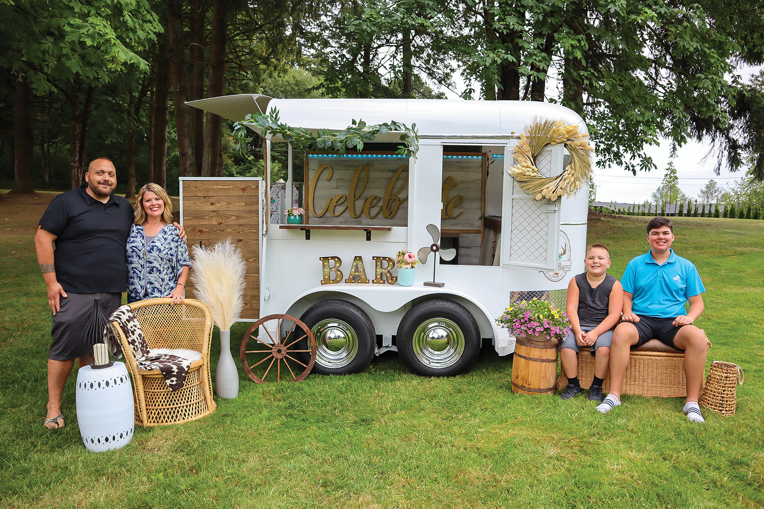Erin Musgrove and her family sit in front of their mobile bar, which offers bartending services at events